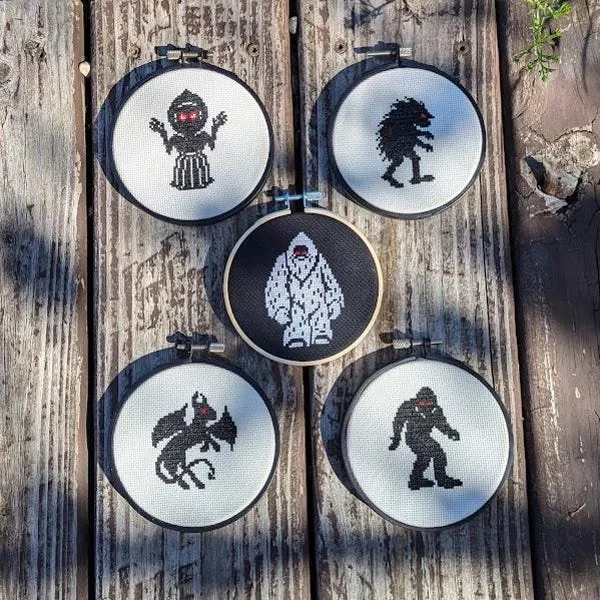 Small cryptid hoops displayed together on aged wood